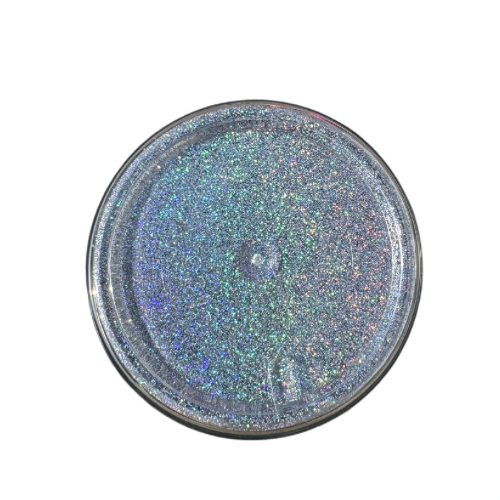 The bottom of jar of silver holographic glitter powder.