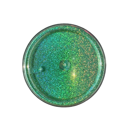The bottom of jar of green holographic glitter powder.