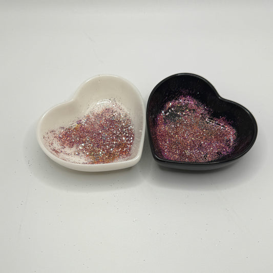A white and black heart shaped dish showing a Silver/Light Teal/Purple/Orange medium glitter mix.