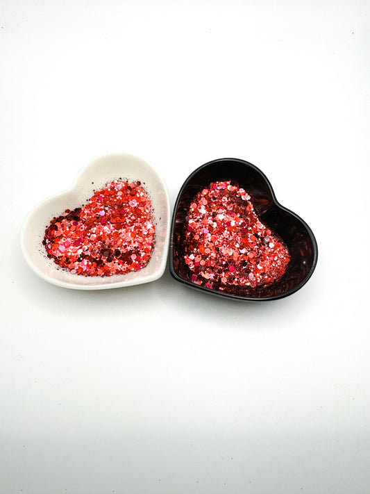 Two heart shaped containers, one black, one white, containing a Light Red/Pink/Light Pink chunky glitter mix.