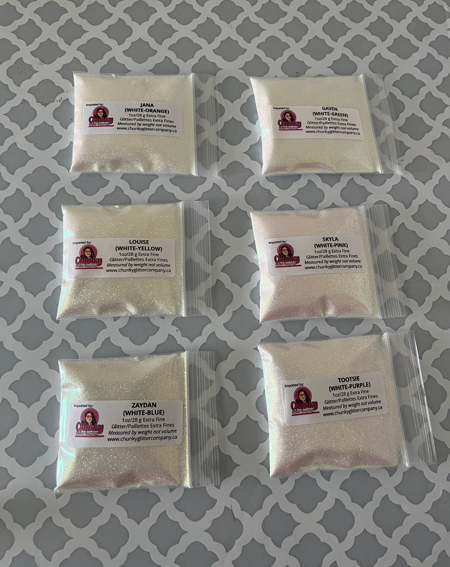 6 packages of white glitter that changes colour in the sunight.