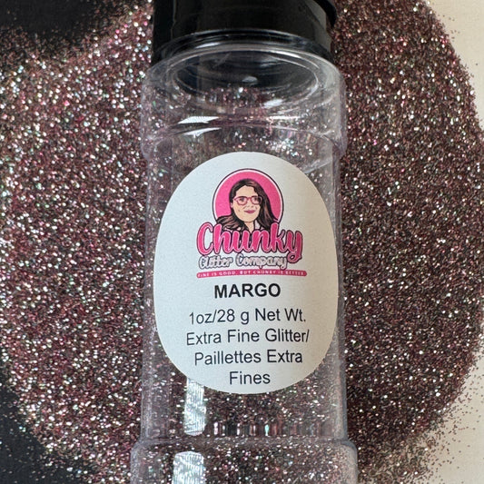 A clear plastic bottle of 'Margo' brand glitter, labeled as extra fine glitter, with a visible pink shimmering substance inside the bottle. The label features a logo and the name 'Margo'.