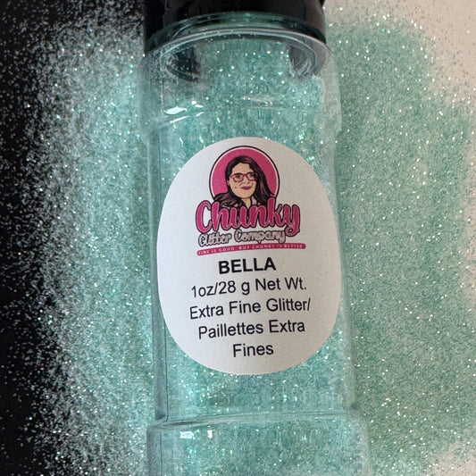 A clear plastic bottle with a black lid, labeled 'Chunky Glitter Company Bella' containing extra fine glitter, in a pastel teal color.