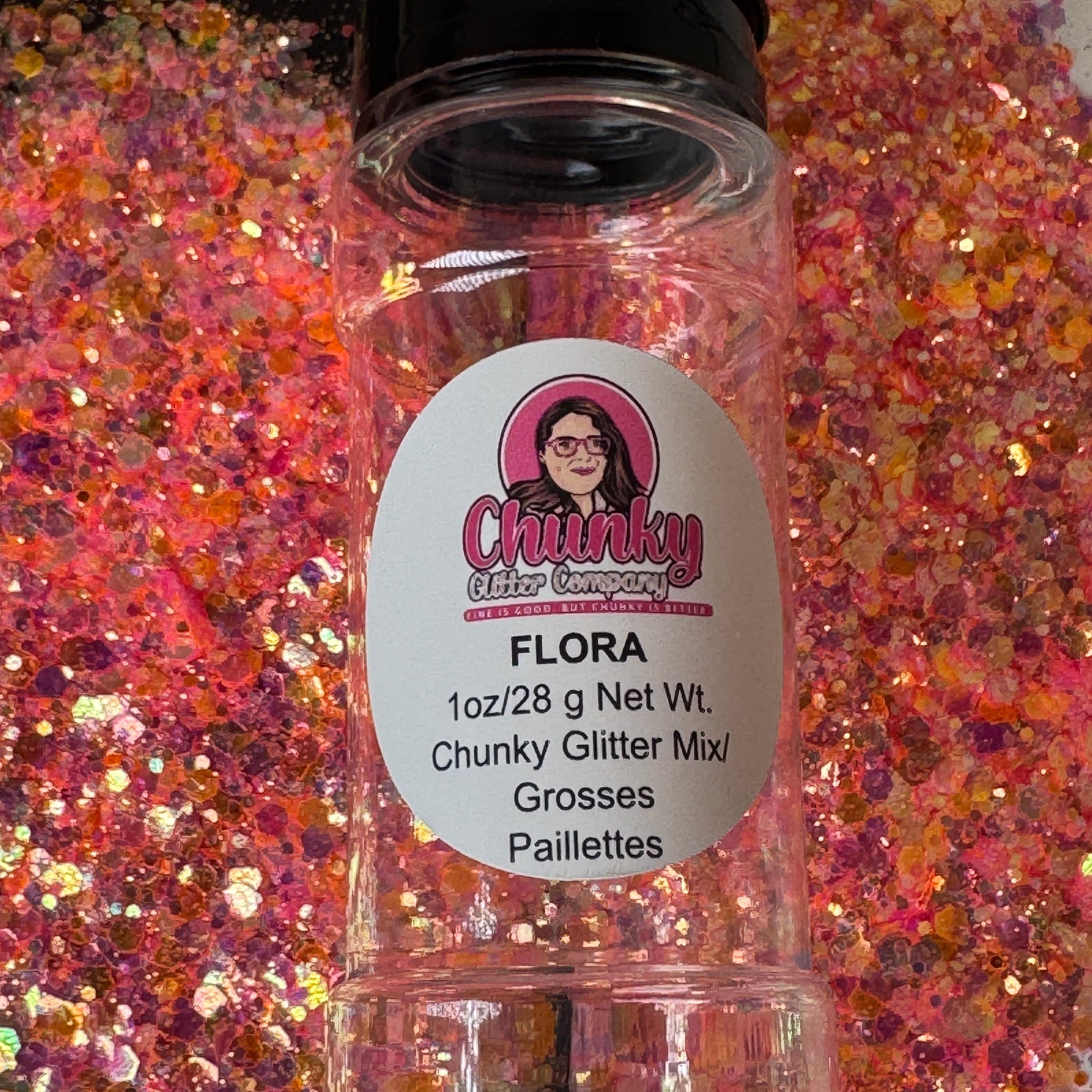 A clear plastic bottle with a label showing 'Flora' by Chunky Glitter Company, containing a Light Pink/Orange chunky glitter mix.