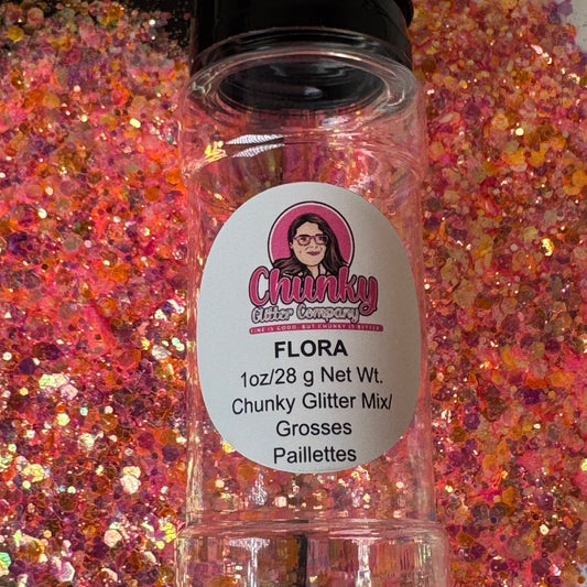 A clear plastic bottle with a label showing 'Flora' by Chunky Glitter Company, containing a Light Pink/Orange chunky glitter mix.
