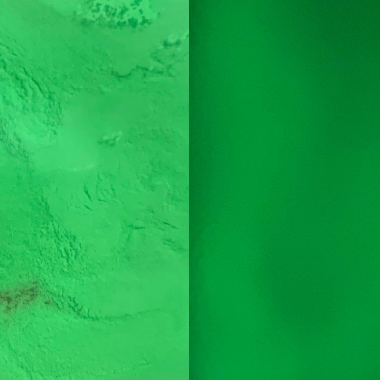 An image showing green glow in the dark powder plain and glowing.