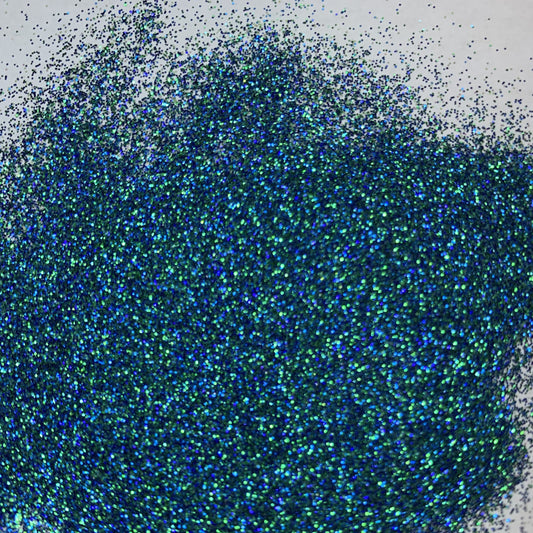 A close-up image of extra fine mix glitter showcasing various blues and greens.