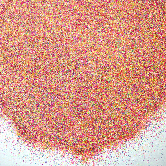 Rainbow matte glitter fanned out on a white background.