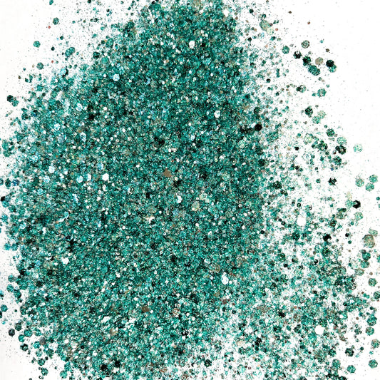 A pile of turquoise and silver colored chunky glitter, not packaged, displayed on a white background.