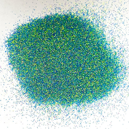 Blue, Green and Yellow matte glitter fanned out on a white background.