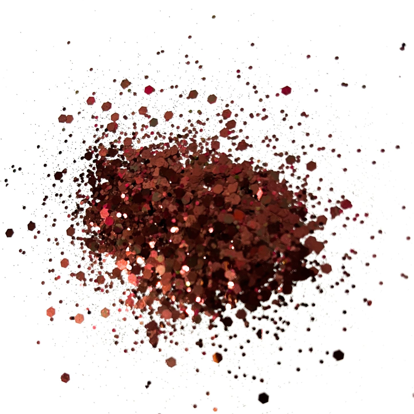 A pile of chocolate brown chunky glitter on a white background.