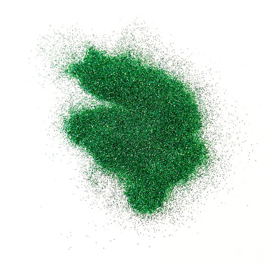 A pile of green glitter on a white background.