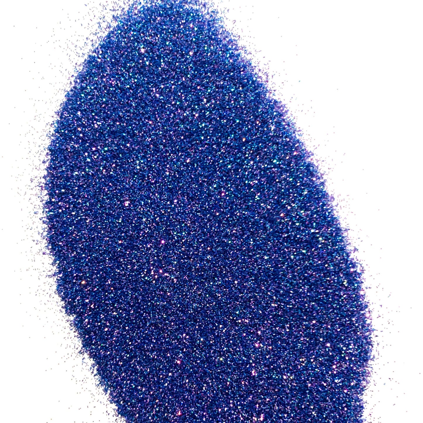 A pile of blue polyester glitter spread out on a white background.