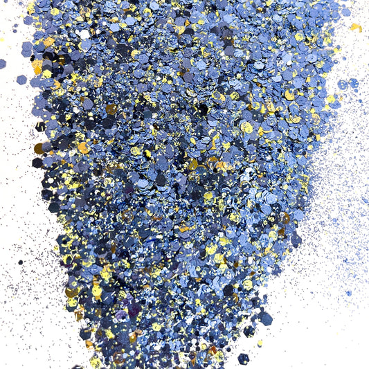 A pile of mixed colours of chunky glitter, including Blue/Yellow/White/Silver on a white background.