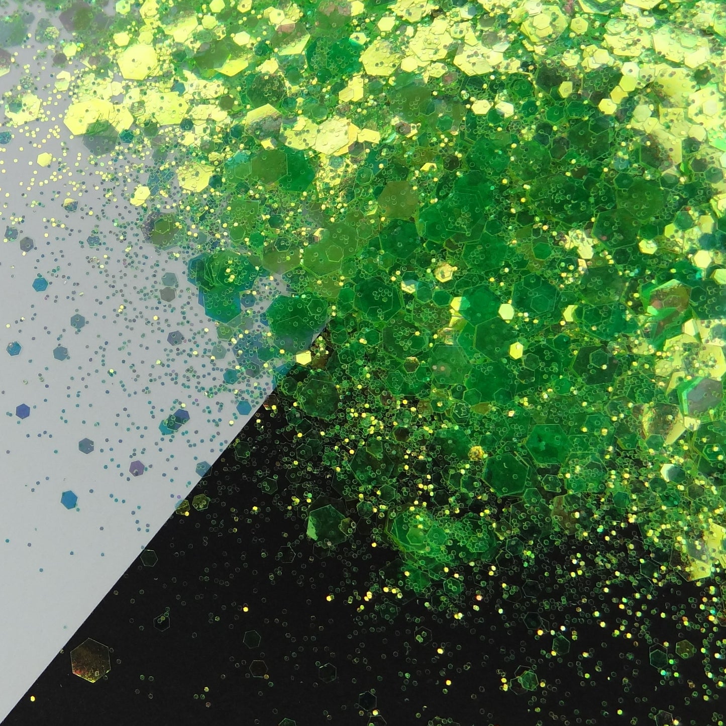 A green chunky glitter mix spread out on a black and white background.