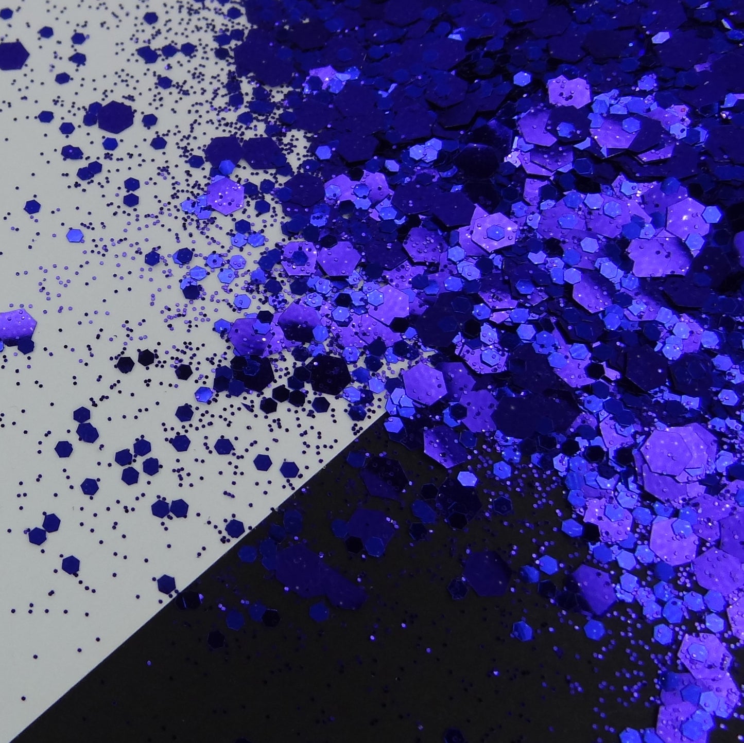 A pile of indigo chunky glitter on a black and white background.