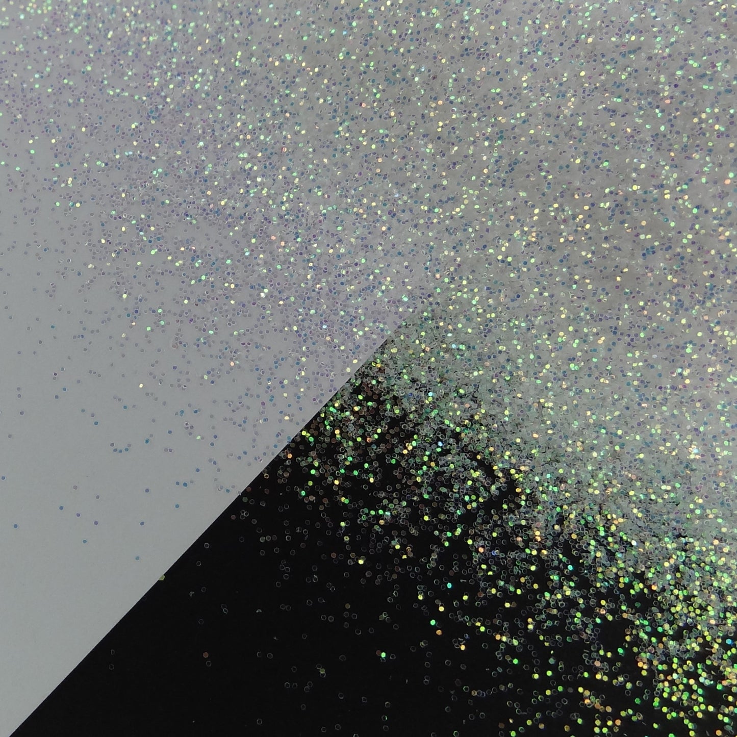 A white extra fine glitter mix spread out on a black and white background.