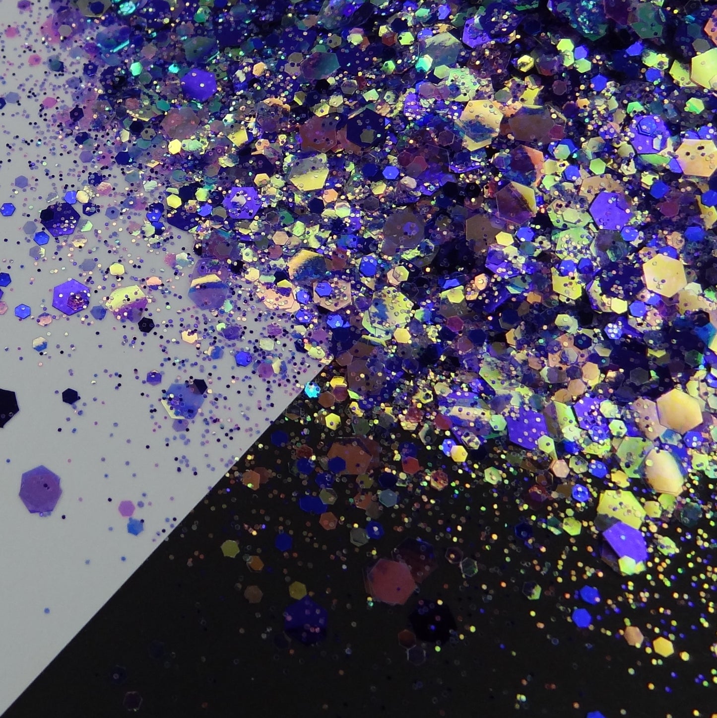 A purple chunky glitter mix spread out on a black and white background.