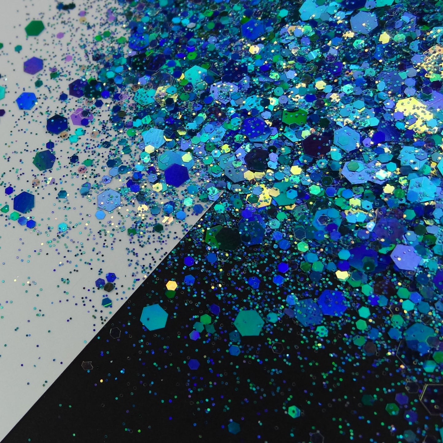 A blue chunky glitter mix spread out on a black and white background.
