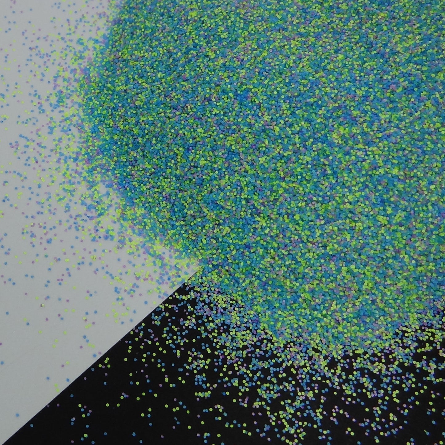 Blue, Green and Yellow matte glitter fanned out on a black and white background.