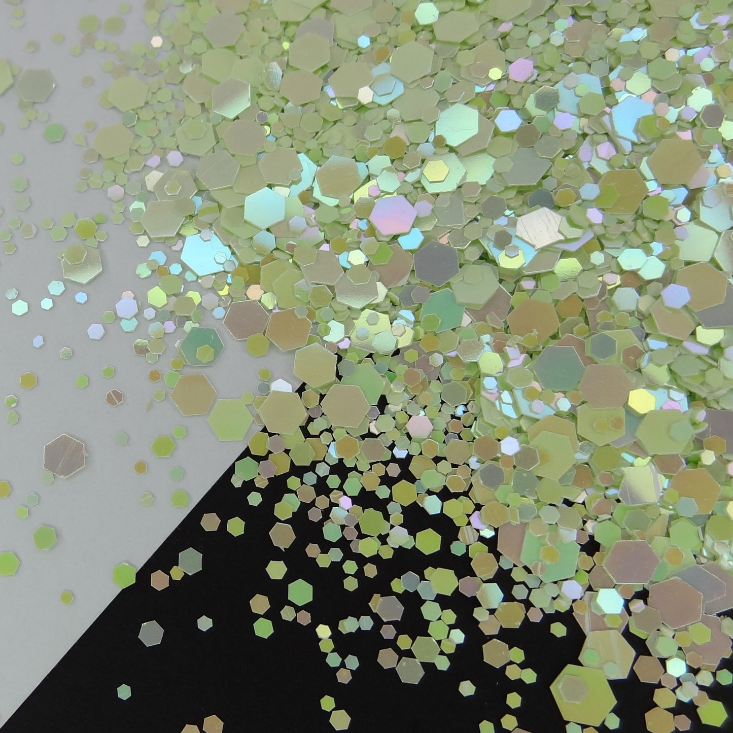 A mint green chameleon rainbow shifting chunky glitter mix on a black and white background.