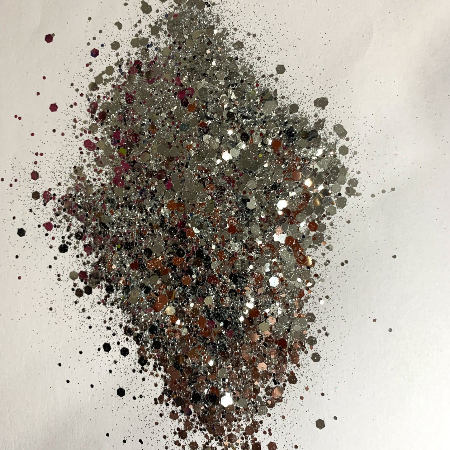 A chunky glitter mix spread out on a white background.