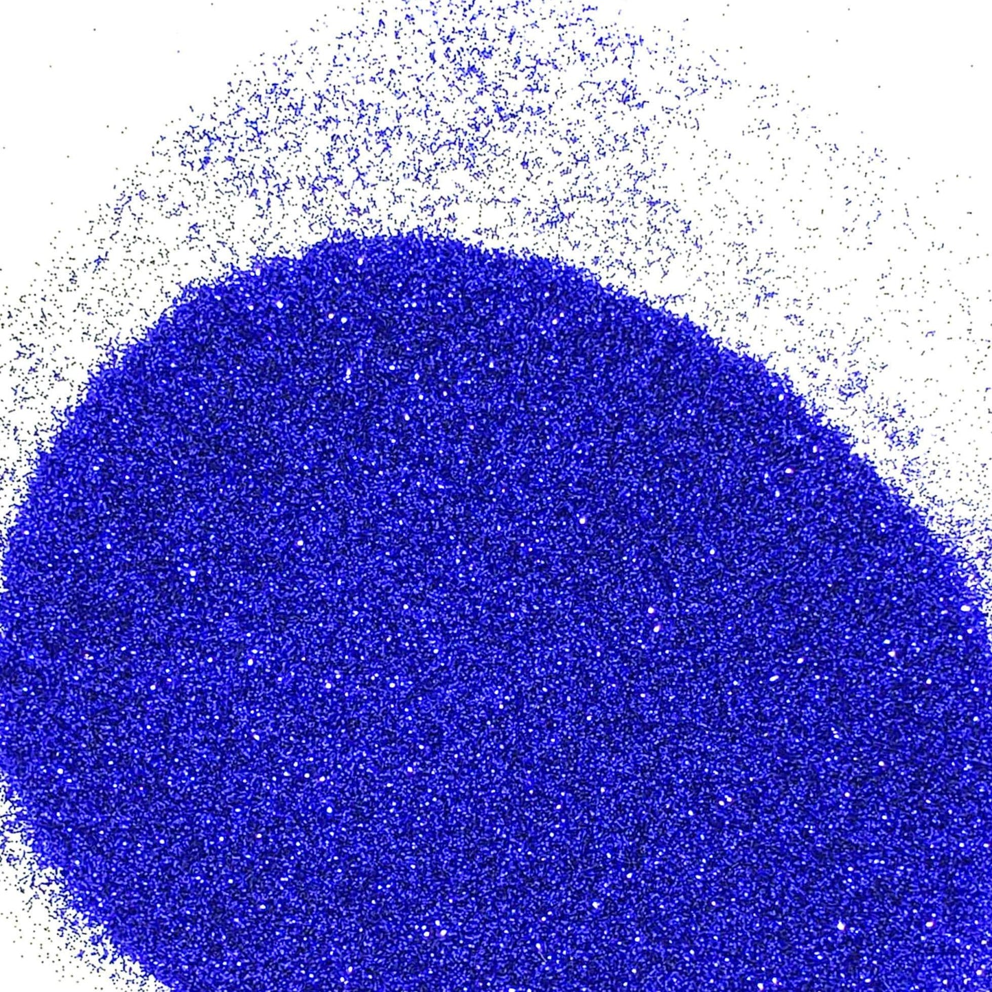 A pile of royal blue navy glitter spread out on a white background.