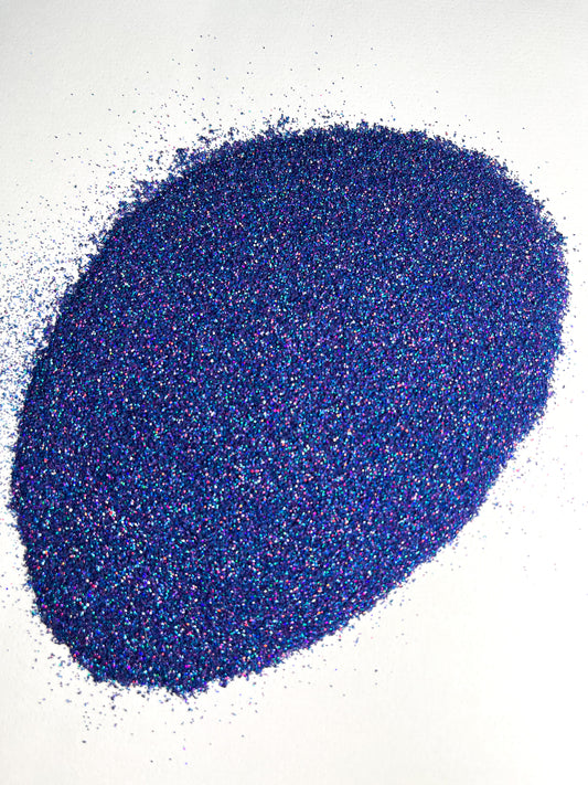 A pile of blue glitter on a white background.