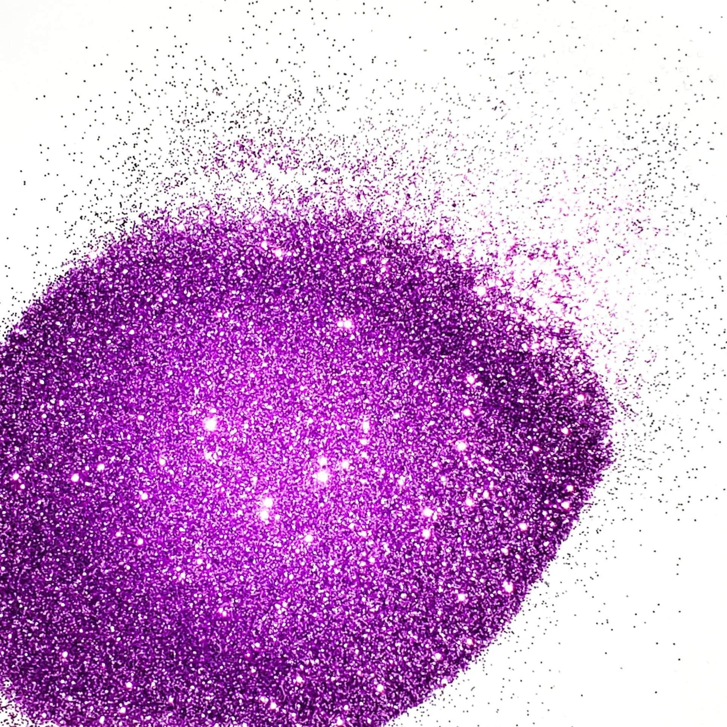 A close-up image of lilac purple colored polyester glitter spread on a surface.