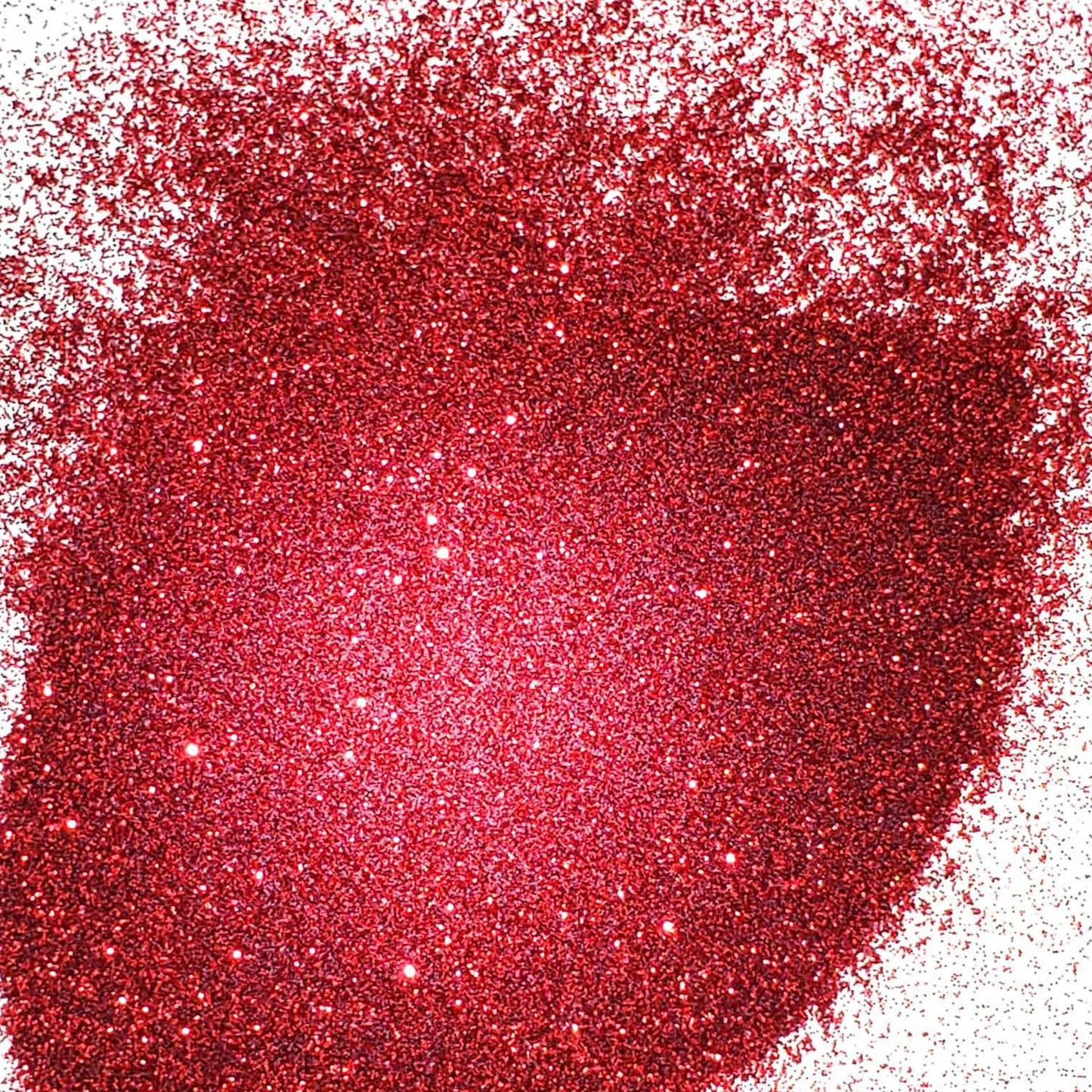 A close-up image of red metallic glitter spread out on a surface.