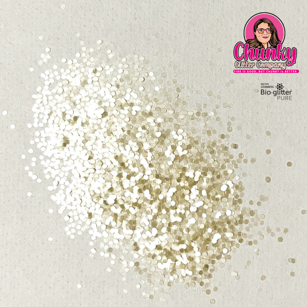 A pile of off white iridescent biodegradable glitter on a white surface with a logo in the corner.