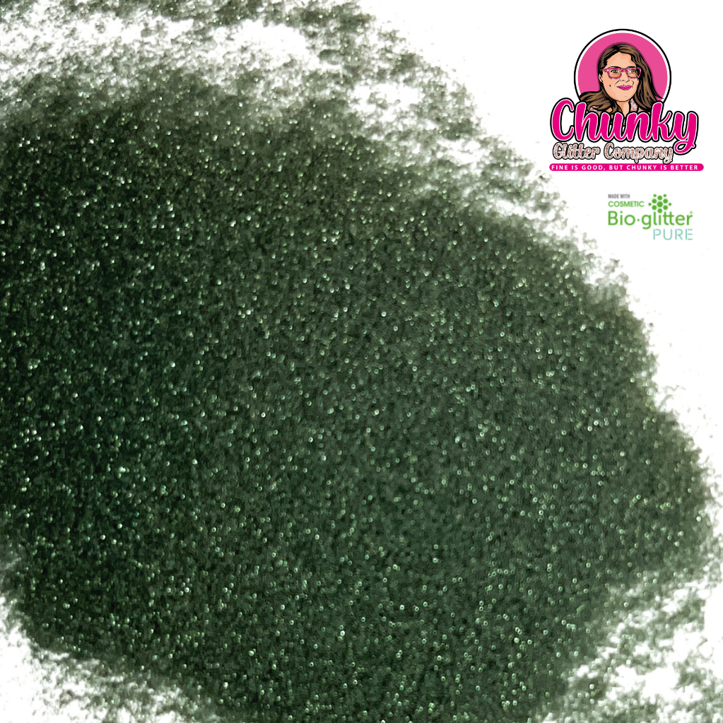A pile of sea green iridescent biodegradable glitter on a white surface with a logo in the corner.