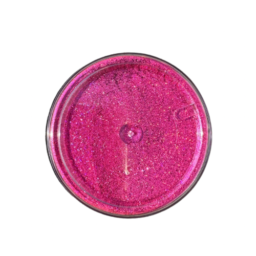 The bottom of jar of pink holographic glitter powder.