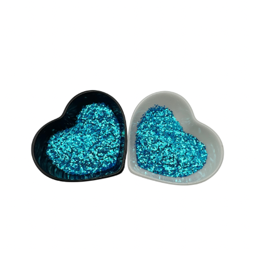 A white and black heart shaped dish showing a Blue medium glitter.