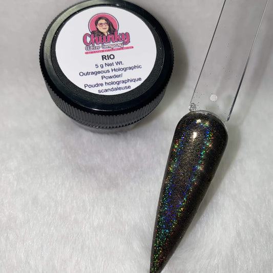 A small jar of black holographic glitter powder next to a sample application on a clear nail.