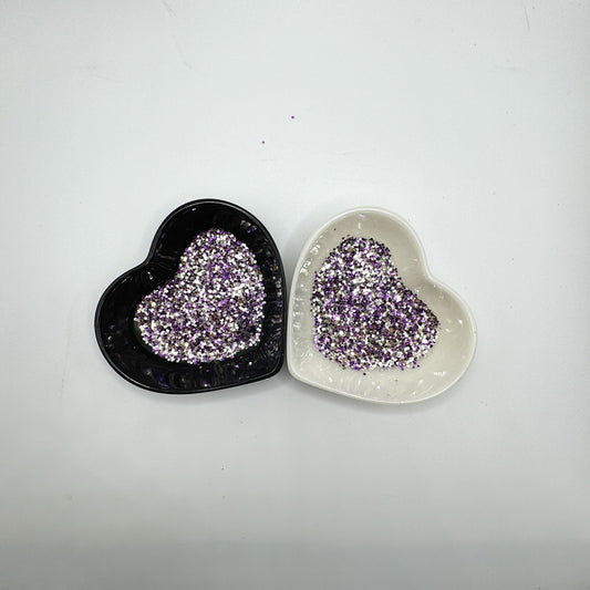 A white and black heart shaped dish showing a Silver/Gold/Purple medium glitter mix.
