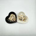 Two heart shaped containers, one black, one white, containing a Bronze/Gold/Silver/Rose Gold chunky glitter mix.