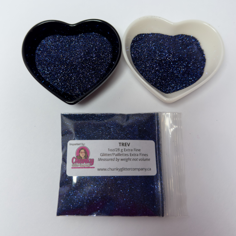 Two heart-shaped containers of glitter, one black and the other white, both showing an extra fine, navy blue glitter mix and a bag of glitter with a label that reads Trev.