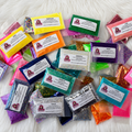 Colorful glitter packets with labels on a white surface