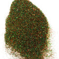 A green/orange  extra fine glitter on a  white background.