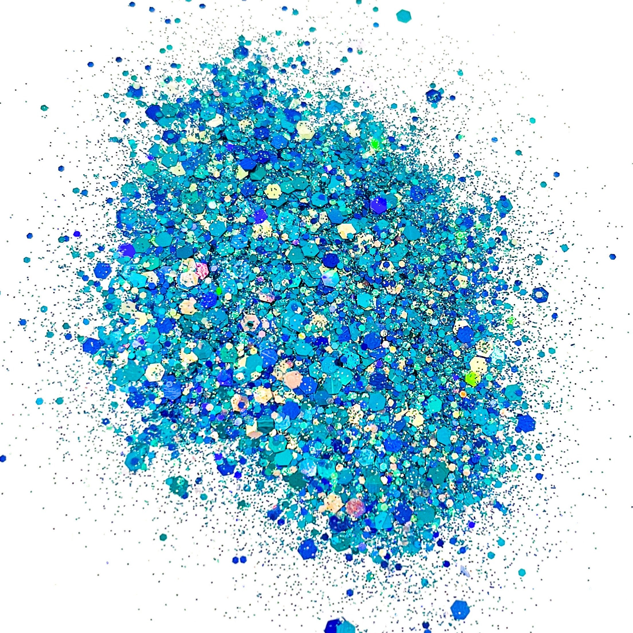 A pile of blue and turquoise colored chunky glitter, spread out on a surface.
