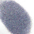 A pile of multicolored holographic glitter, with colors including blue and silver, spread out on a surface.