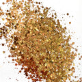 A rose gold and bronze chunky glitter mix on a white background.
