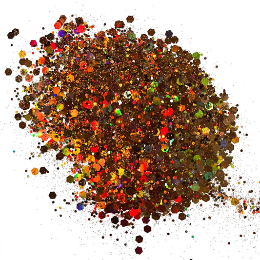A pile of multicolored chunky glitter, ranging from brown to vibrant hues, spread out on a surface.