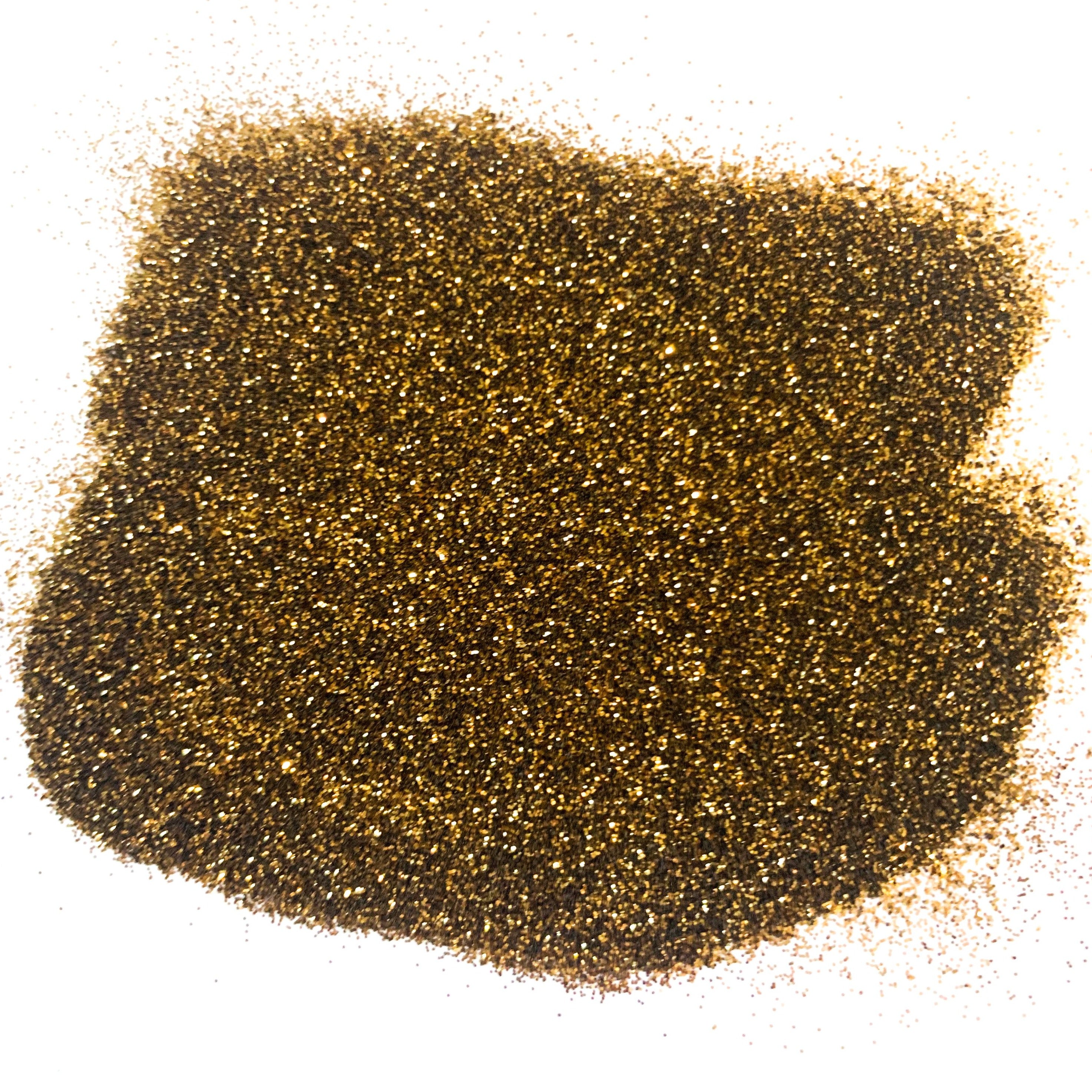 A pile of brown, extra fine glitter spread out on a surface.