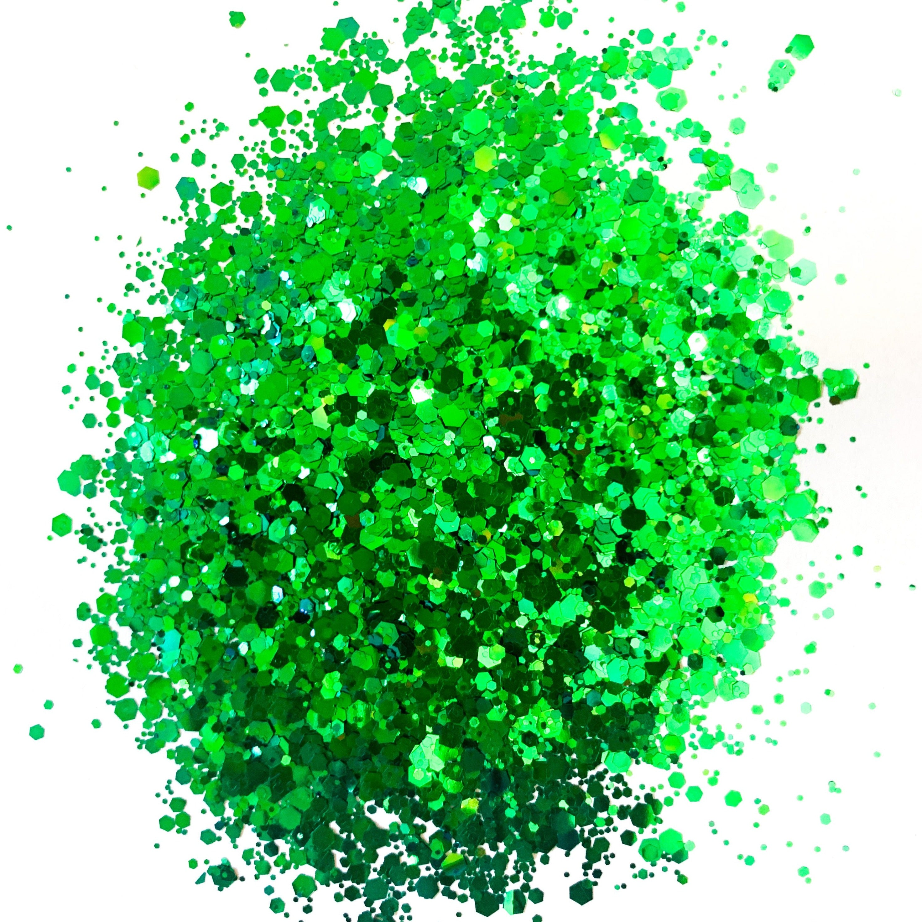 A green metallic chunky glitter in a pile on a white background.
