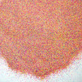 Rainbow matte glitter fanned out on a white background.