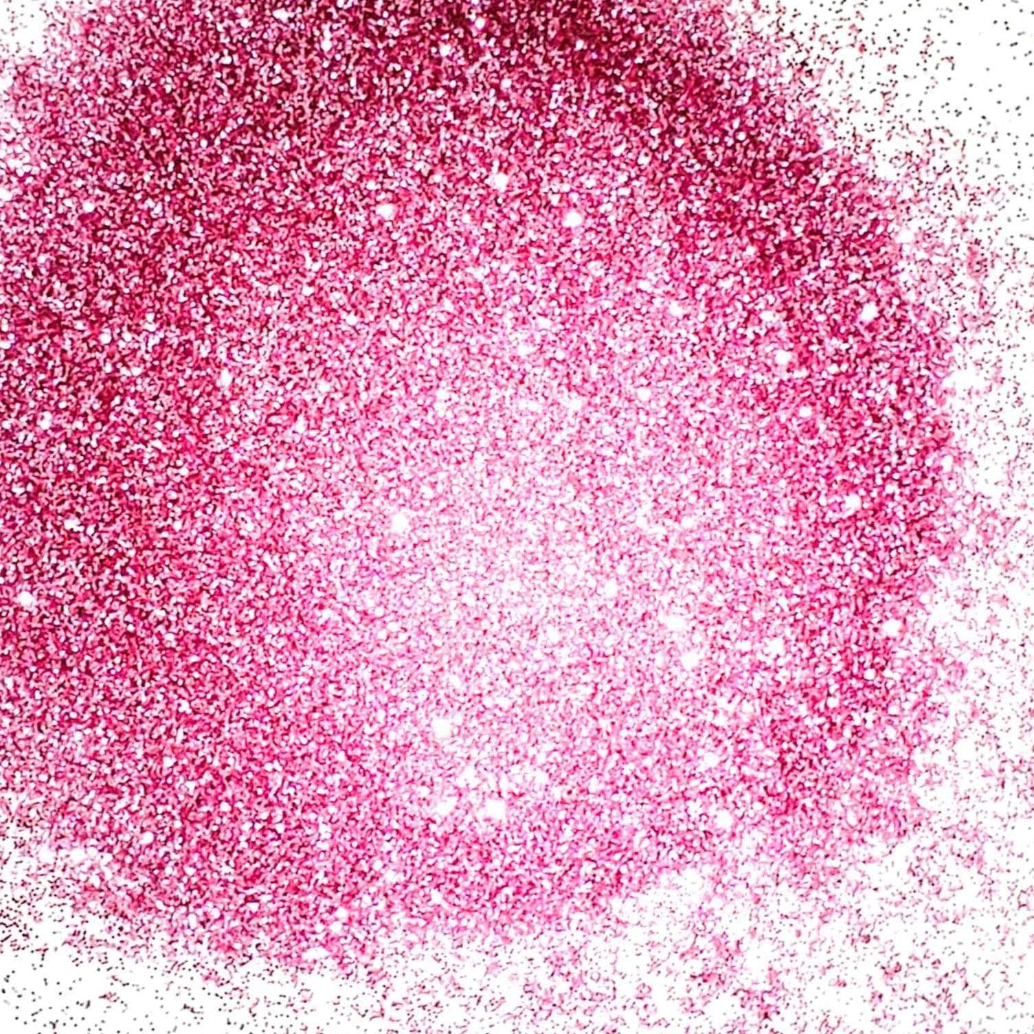 A close-up image of pink glitter, showing the texture and reflecting sparkles.