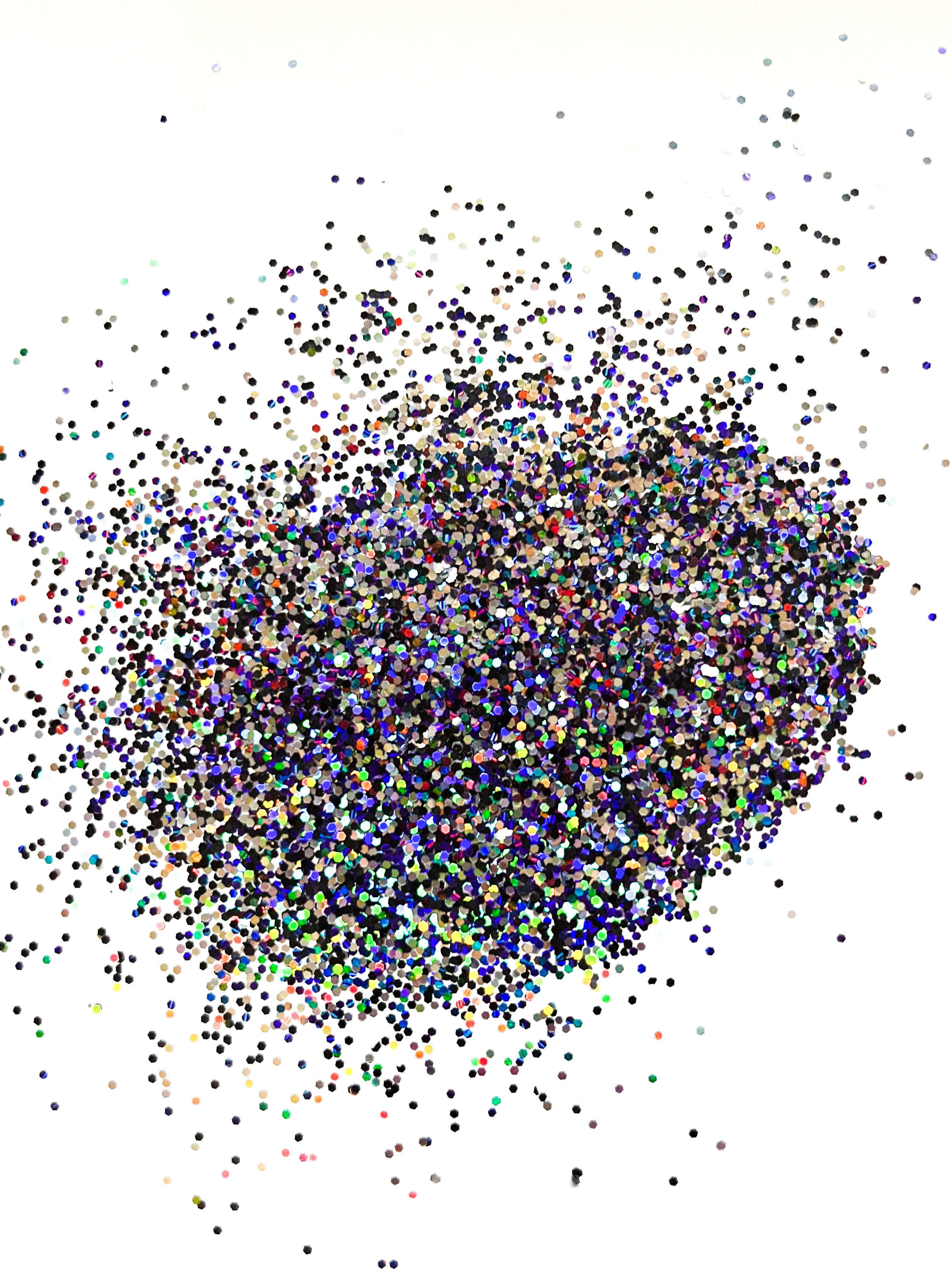 A pile of multicolored chunky holographic glitter with a mix of black, silver, and purple hues.