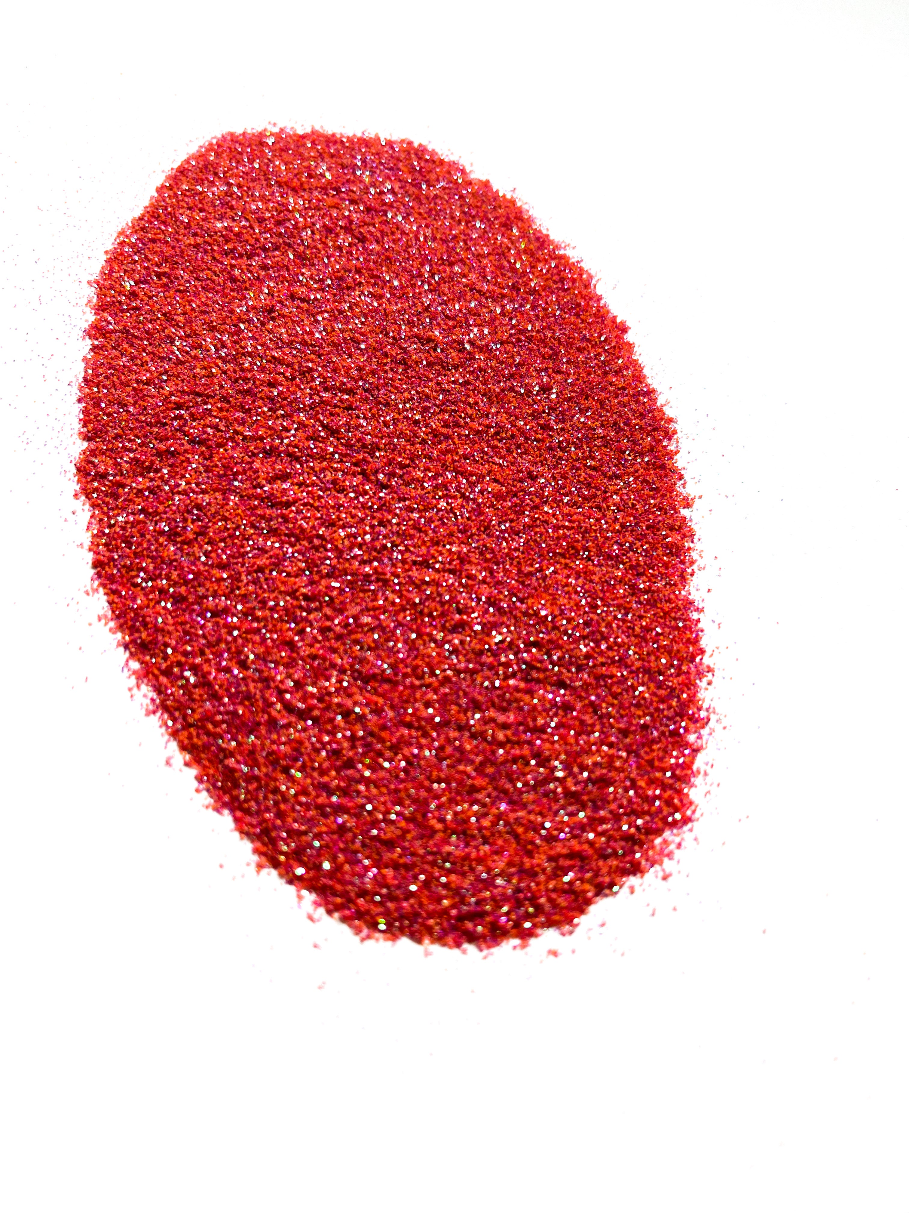 A pile of red glitter on a white background